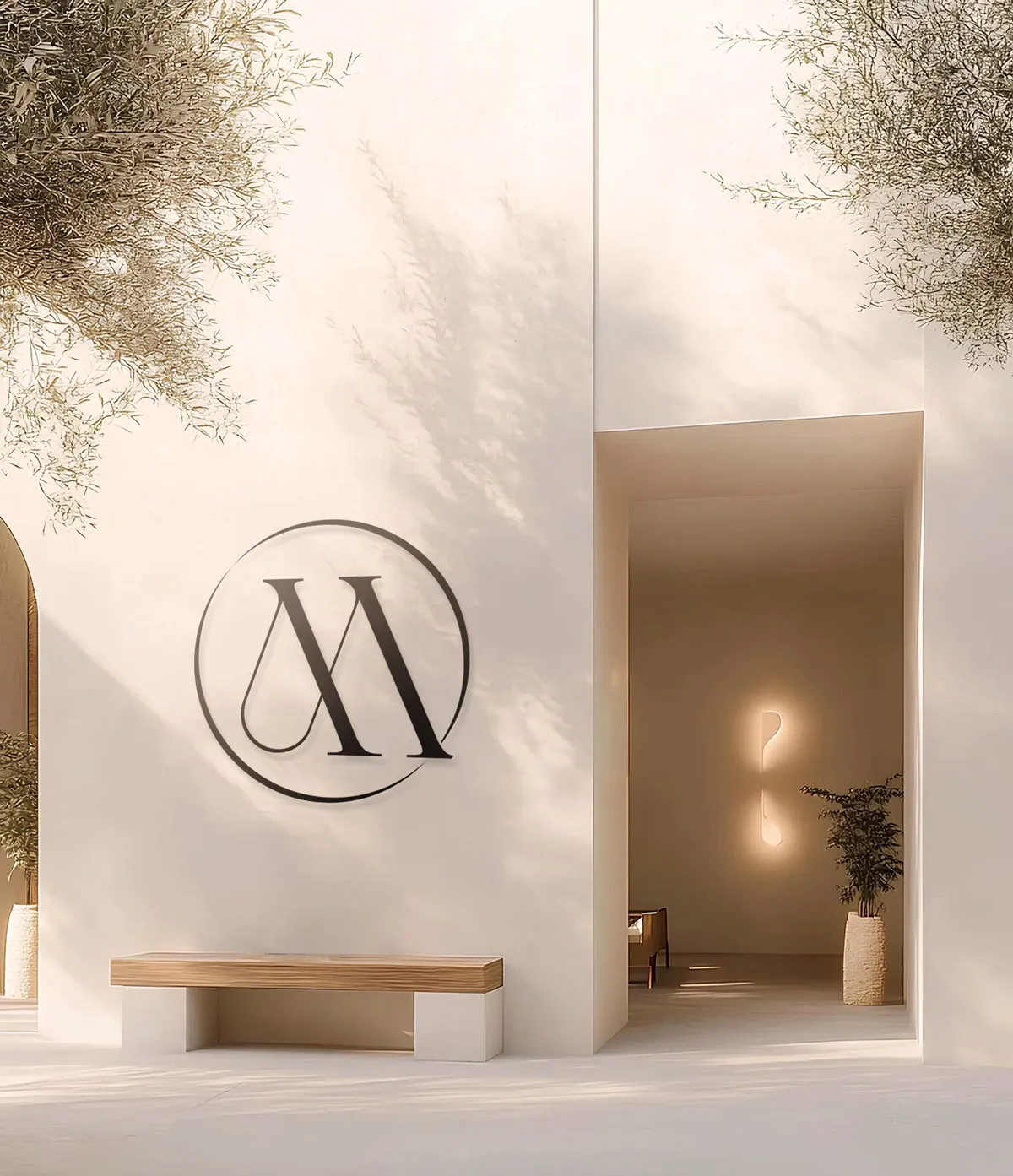 The Marrakech Oil 'M' monogram logo displayed as signage on an exterior wall, demonstrating environmental branding for a luxury skincare spa or store.